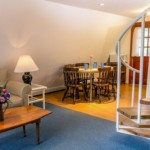 Robin cottage living and dining area with spiral stairs